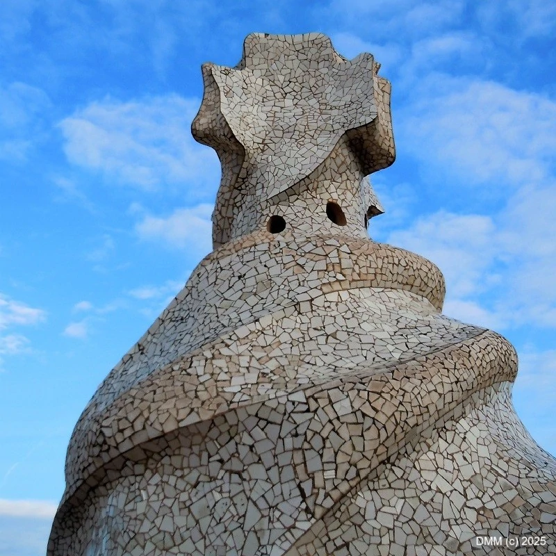 Bold architecture designed by Antonia Gaudi with blue skies Barcelona Spain photo